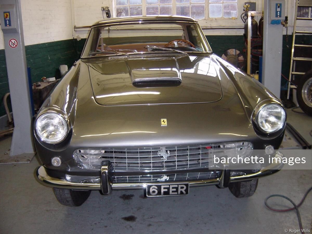 Ferrari 250 GT Pininfarina Coupe s/n 1479GT
matching engine and chassis numbers. 1959 ... Originally White with a Turquiose roof. The roof was Verde-Azzurro and the body was Bianco Max Mayer with a black leather interior. Left Hand Drive. Drum brakes. Borani wire wheels. Inside plug engine. Bonnet scoop. One of very few cars fitted by factory with Lucas electrics (for UK use).  First supplied to Garage Francorchamps in 1959.         1959-1997 - McCloud Moore family, UK - registered 123MOB.          1992 - Engine rebuild by Terry Hoyle, UK. 1998 - sold to Pieter Boel, Netherlands. Then sold onto Mr W Driessen, Netherlands, registered as AH 18 88  2000/November  Purchased by David Cooke, UK via VSOC Netherlands with intention to convert to Tour de France replica. Serviced at Neil Twyman, UK  2001/November  - purchased by Roger Wills at H&H auction. Registered OSL384. Rosso chiaro / black leather. 2003/04 - full restoration and rebuild - colour changed to Gunmetal Grey (code Fer 6336011 Grigio Ferro), interior d